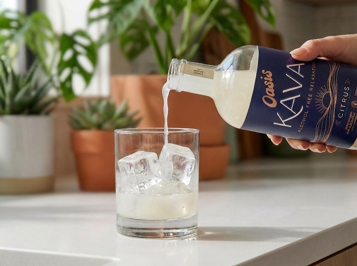 Pouring Oasis Kava Spirit over ice
